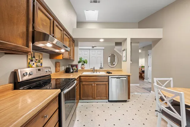 a kitchen with a sink appliances and cabinets