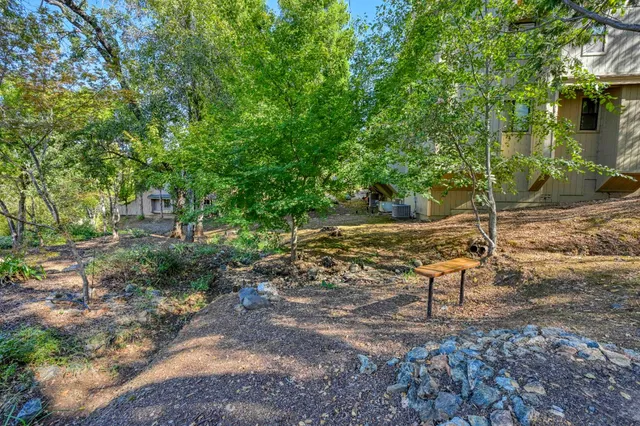 a view of a house with a yard and sitting area