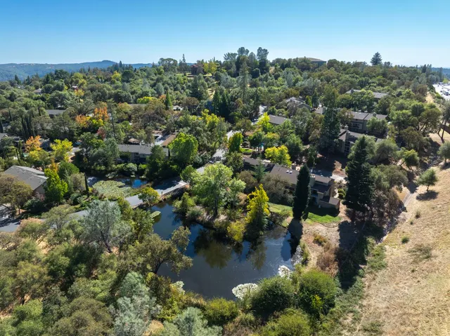 an aerial view of a house with a yard
