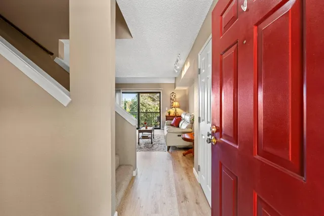 a view of a balcony with couch and wooden floor