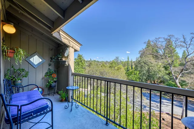 a view of a chair and tables in the balcony