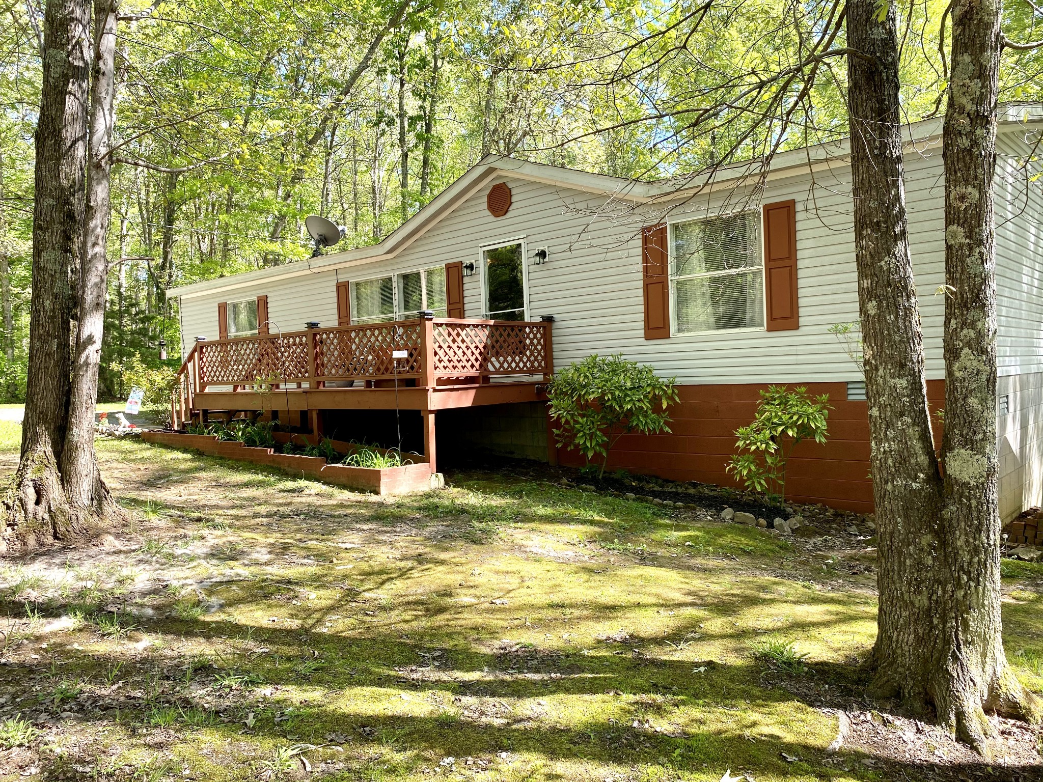 a front view of a house with a garden and yard