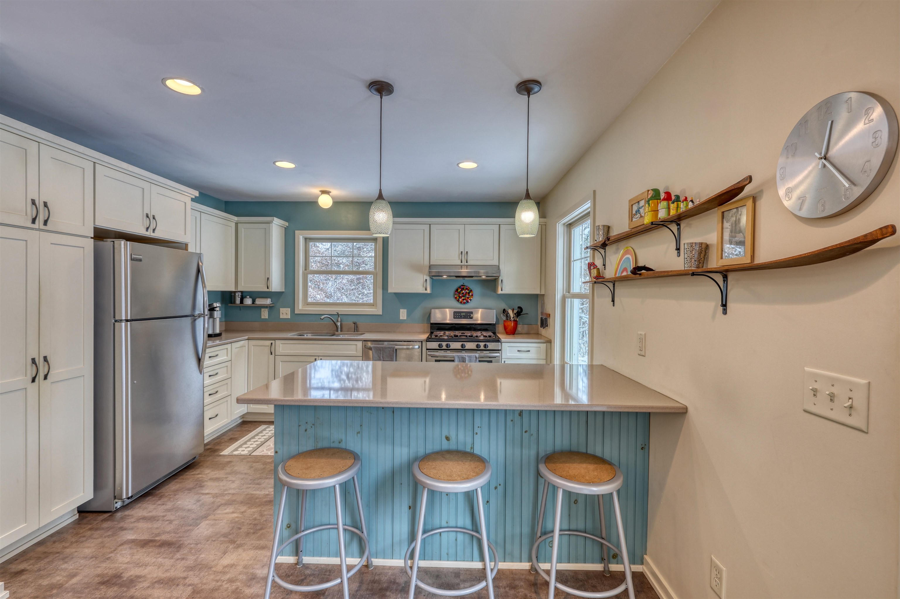8056 North North Road Springbrook, WI 54875 - Photo 22 of 65 Kitchen featuring a kitchen breakfast bar, appliances with stainless steel finishes, a peninsula, hanging light fixtures, and open shelves