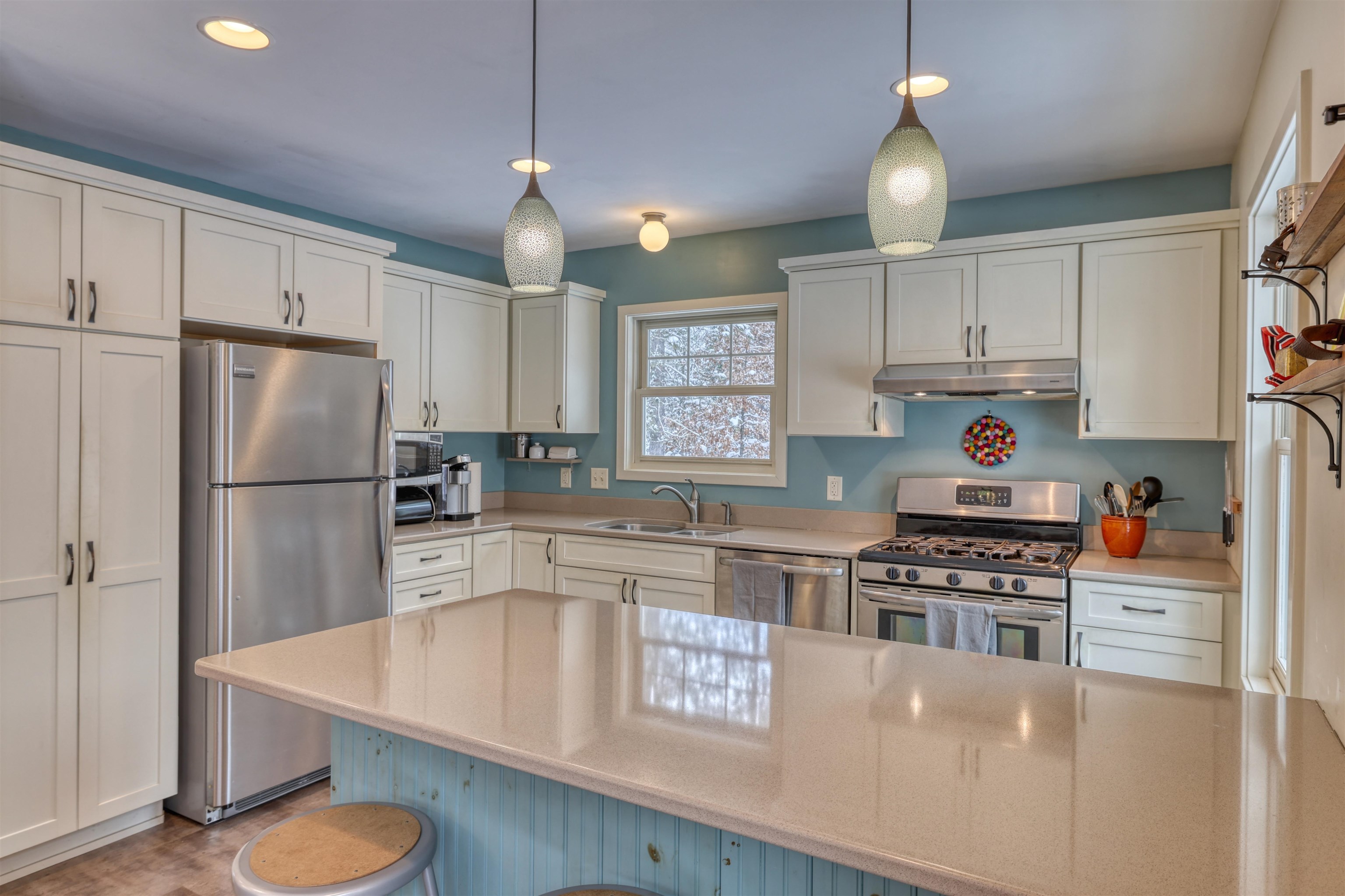 8056 North North Road Springbrook, WI 54875 - Photo 23 of 65 Kitchen with appliances with stainless steel finishes, white cabinets, a kitchen bar, and recessed lighting
