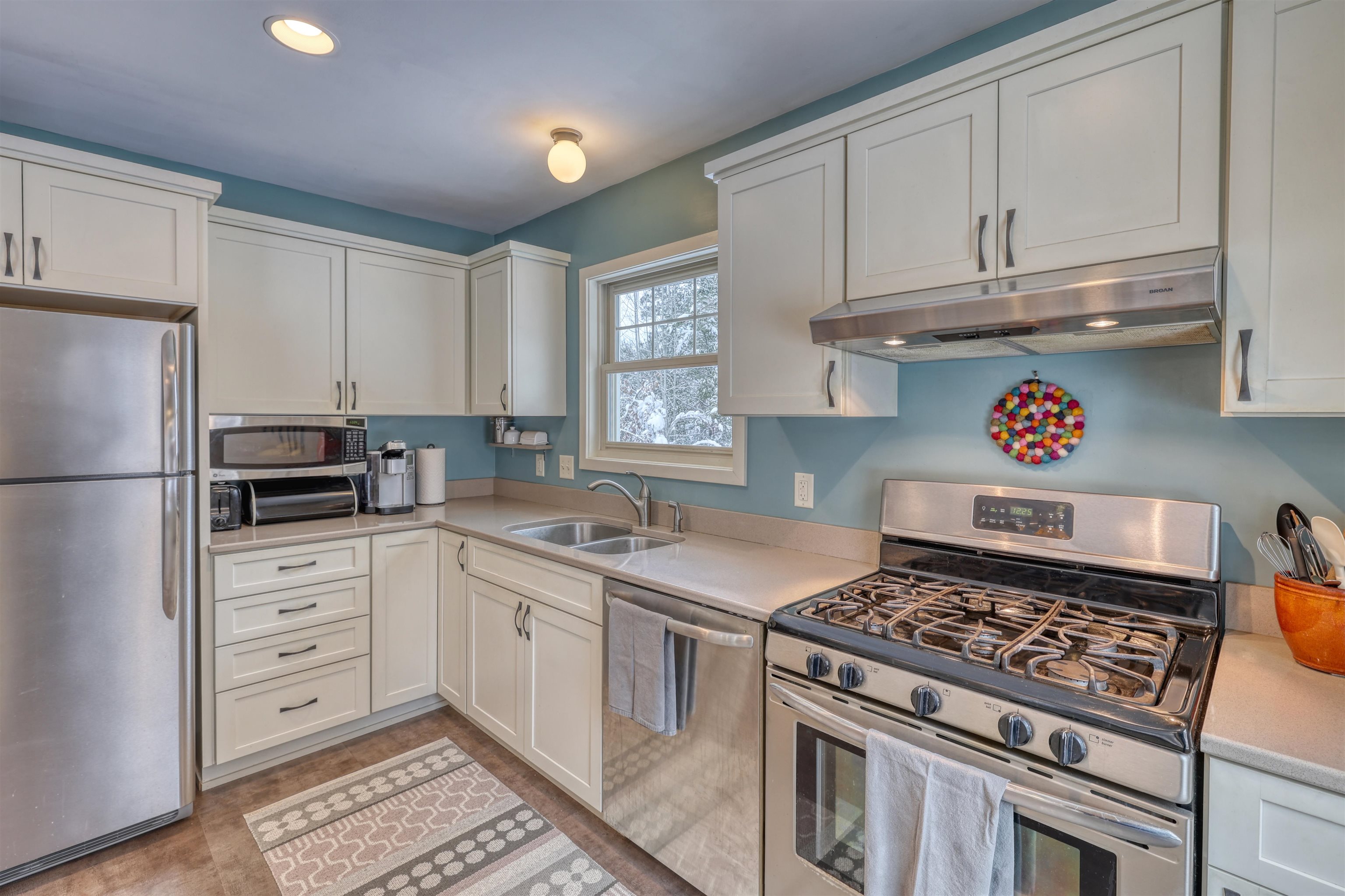 8056 North North Road Springbrook, WI 54875 - Photo 24 of 65 Kitchen with appliances with stainless steel finishes, under cabinet range hood, white cabinetry, and recessed lighting