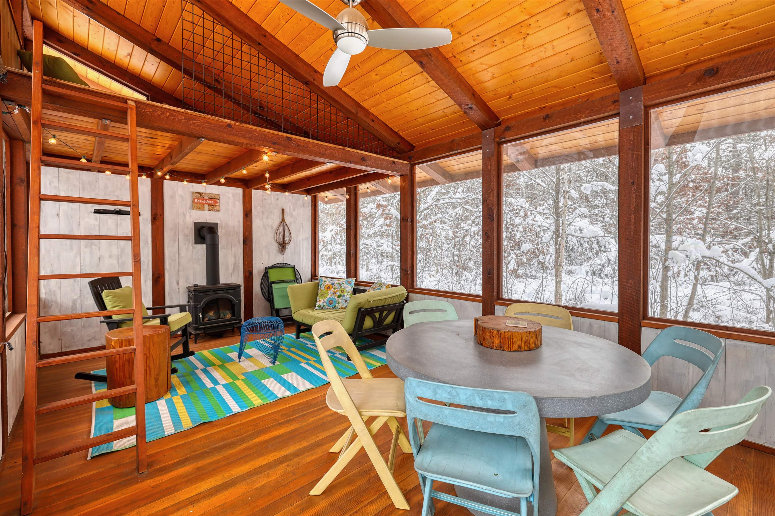 8056 North North Road Springbrook, WI 54875 - Photo 39 of 65 Sunroom / solarium featuring a wood stove, a wood ceiling with exposed beams, and hardwood / wood-style floors