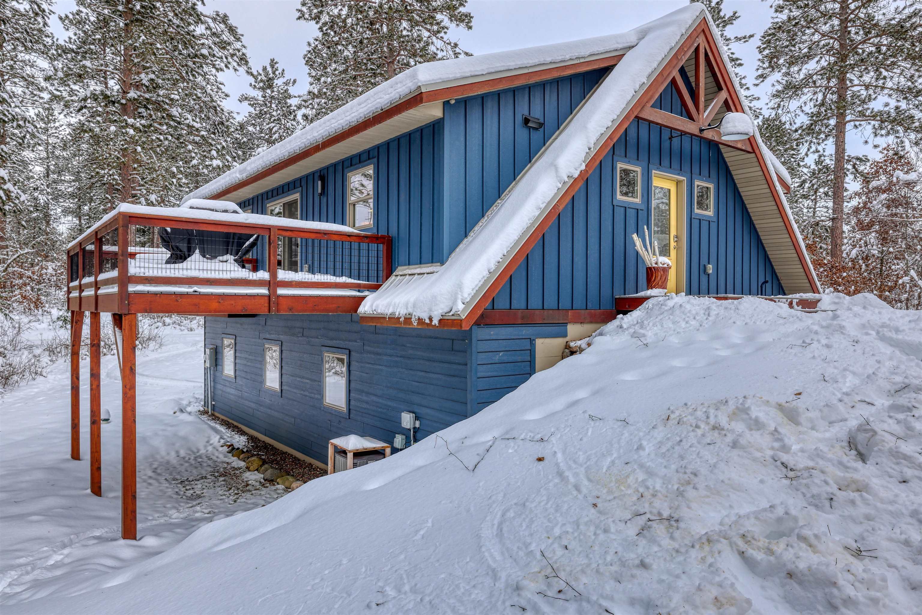 8056 North North Road Springbrook, WI 54875 - Photo 44 of 65 View of snow covered exterior with a wooden deck and board and batten siding