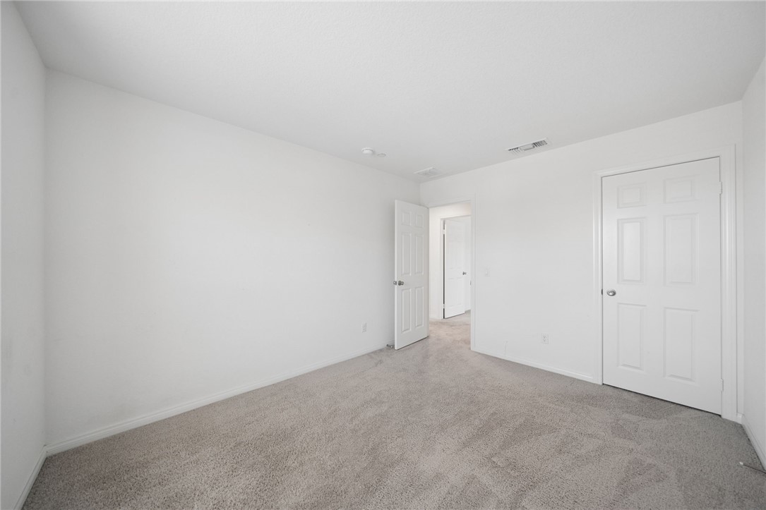 20130 Curaco Court Riverside, CA 92507 - Photo 36 of 43 Bedroom view showing the closet and hallway entrance.
