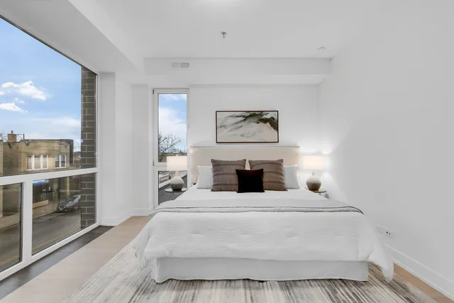 a large white bed in a white room