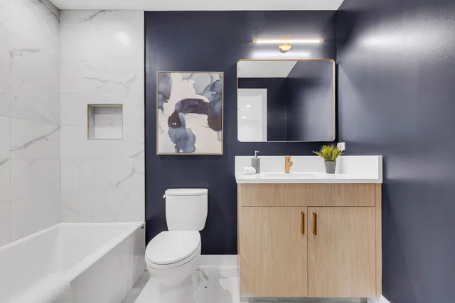 a bathroom with a toilet sink and mirror