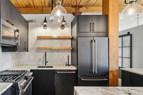 a kitchen with stainless steel appliances granite countertop a stove and a refrigerator