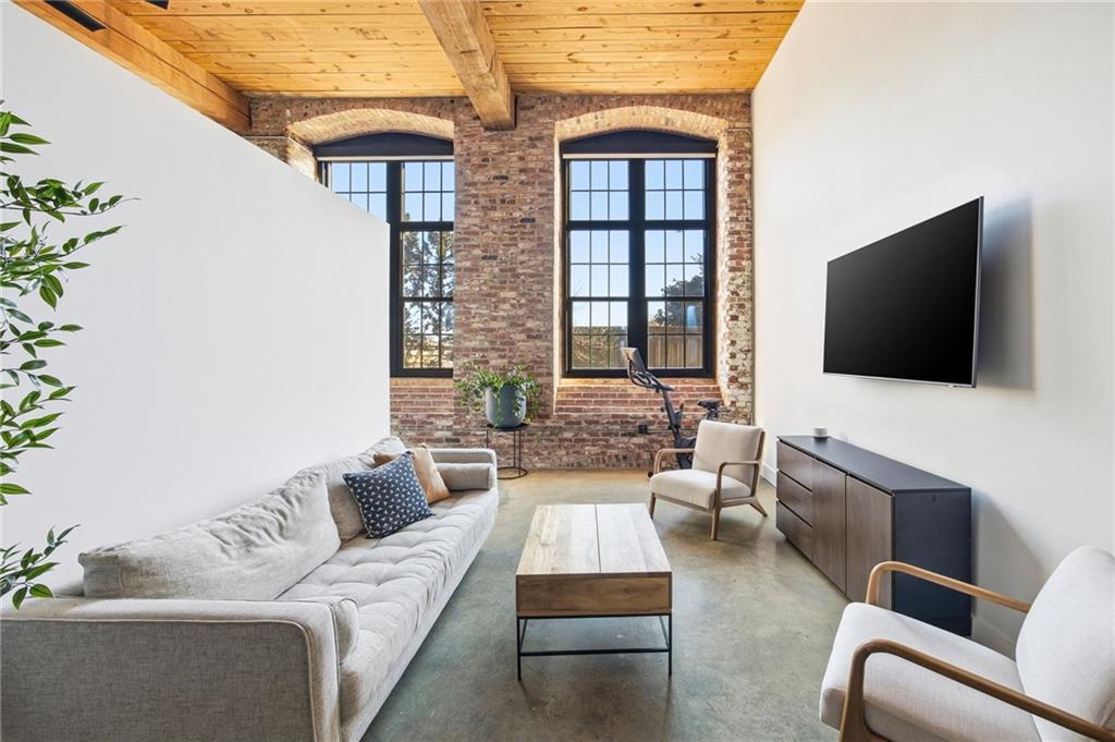 170 Boulevard Southeast, Unit H213 Atlanta, GA 30312 - Photo 4 of 22 a living room with furniture and a flat screen tv