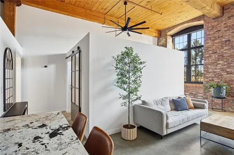 a living room with furniture and a potted plant