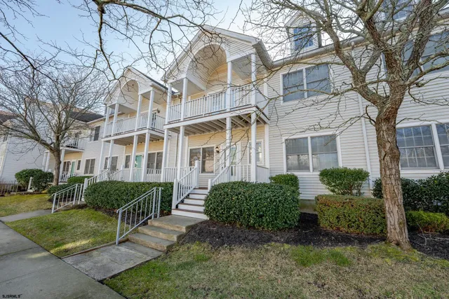 a view of a brick building next to a yard