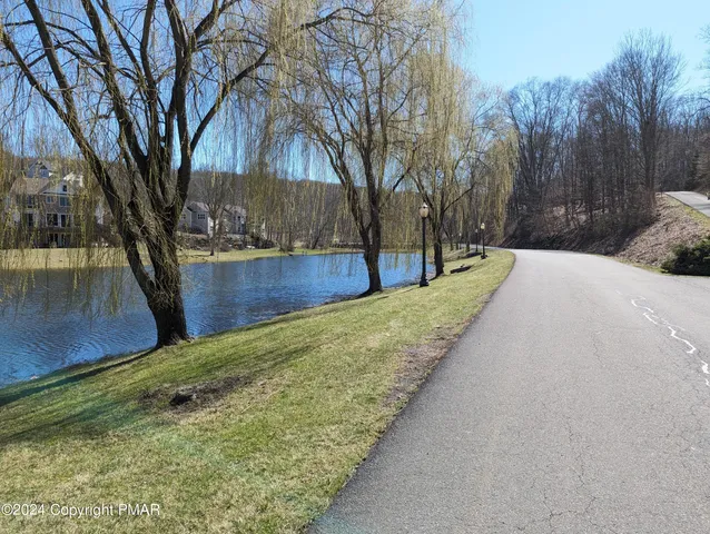 a view of a backyard with wooden fence