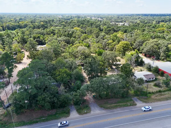 an aerial view of a house with yard