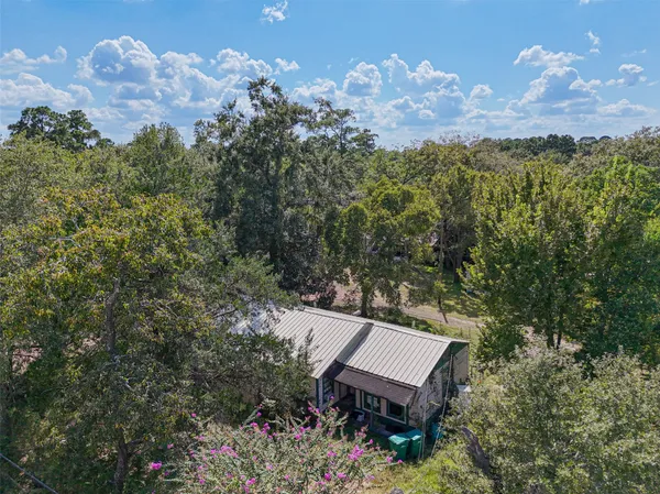 an aerial view of a house with a yard