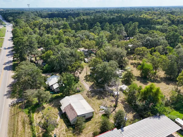 an aerial view of a house with a yard