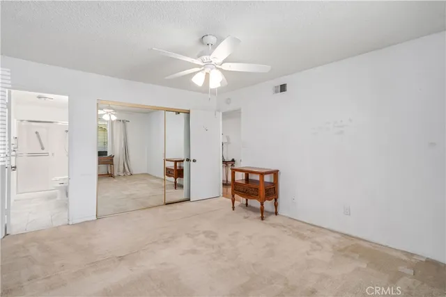 a view of a livingroom with furniture and chandelier fan