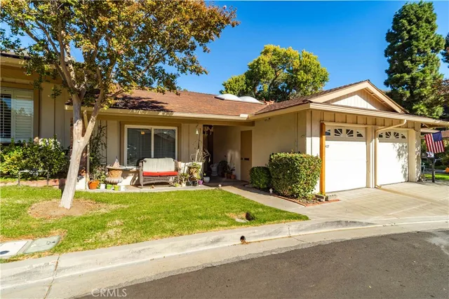 a view of a house with a yard and porch