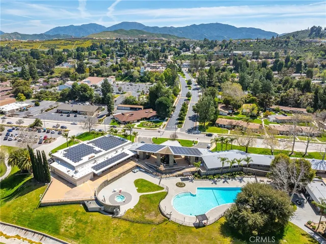 an aerial view of a swimming pool with mountain view