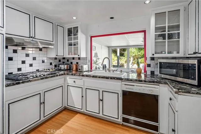 a kitchen with stainless steel appliances granite countertop a stove and a microwave