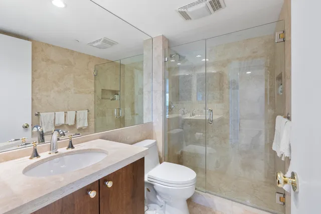 a bathroom with a sink toilet and shower