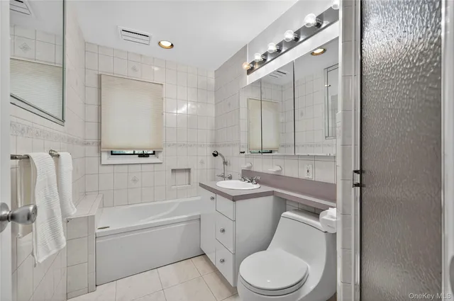 a bathroom with a toilet sink and bathtub