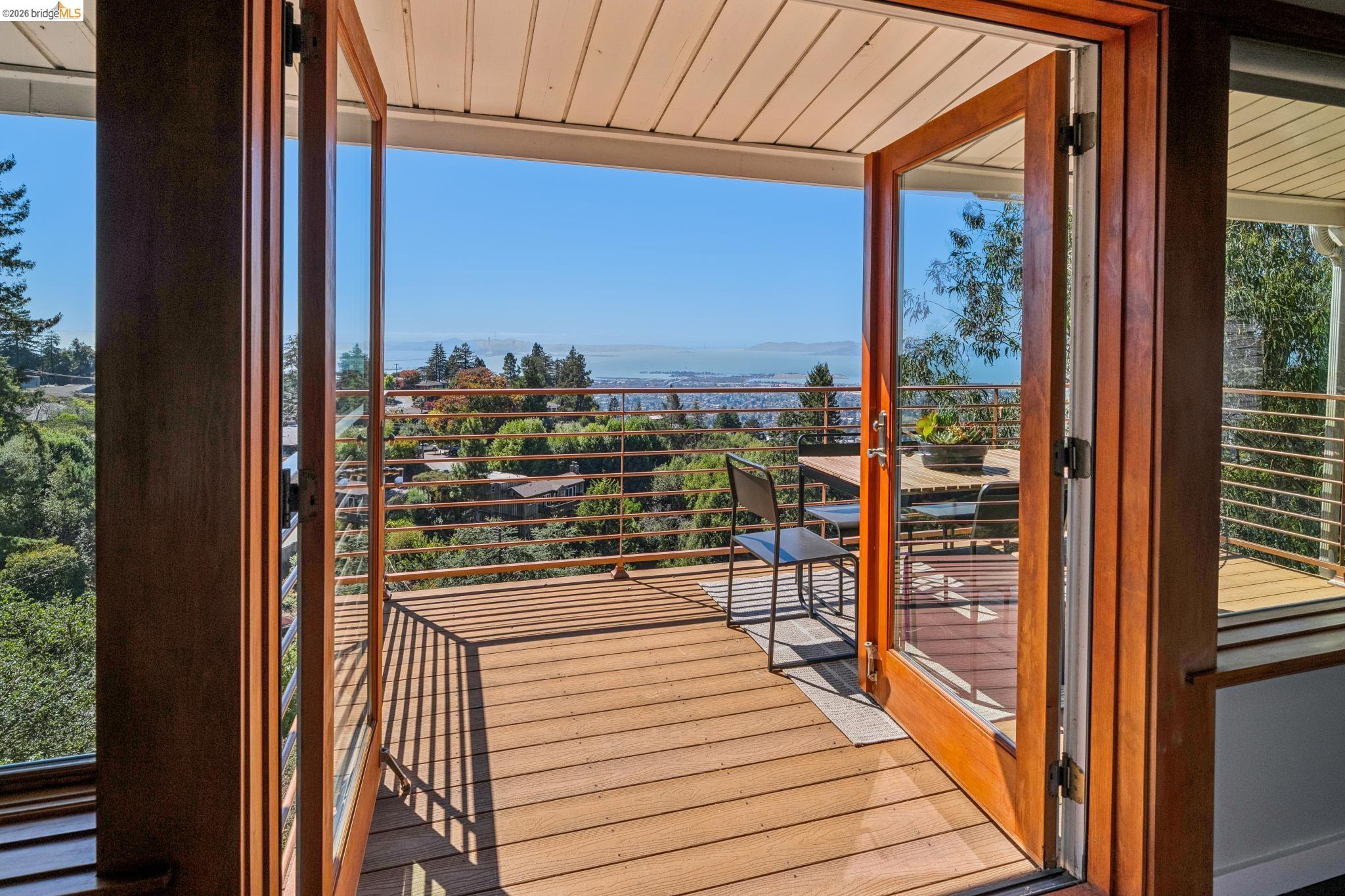 1394 Queens Road Berkeley, CA 94708 - Photo 16 of 63 Expansive outdoor deck featuring wood-finish flooring, a cable railing system, and glass-paneled French doors