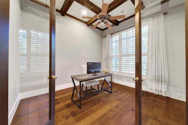 a spacious bedroom with a bed and a flat screen tv