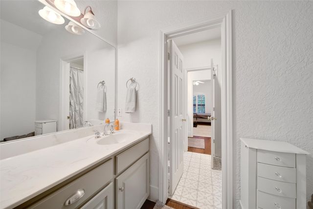 a hallway with a computer on a desk and chair