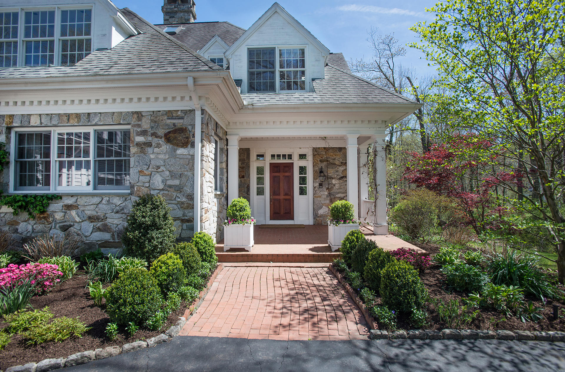 65 Sunset Hill Road New Canaan, CT 06840 - Photo 1 of 21 a view of a house with potted plants