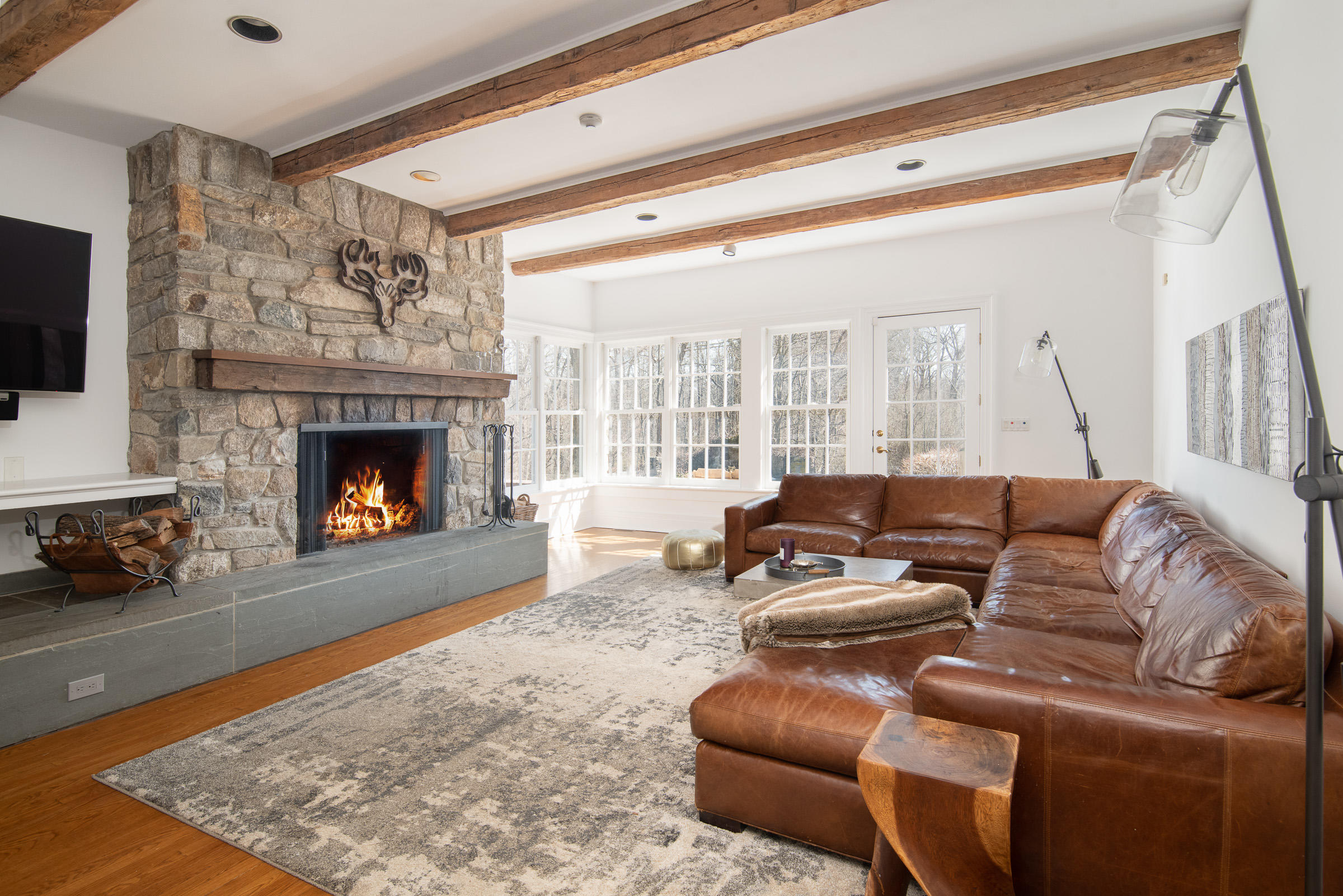 65 Sunset Hill Road New Canaan, CT 06840 - Photo 11 of 21 a living room with furniture and a fireplace