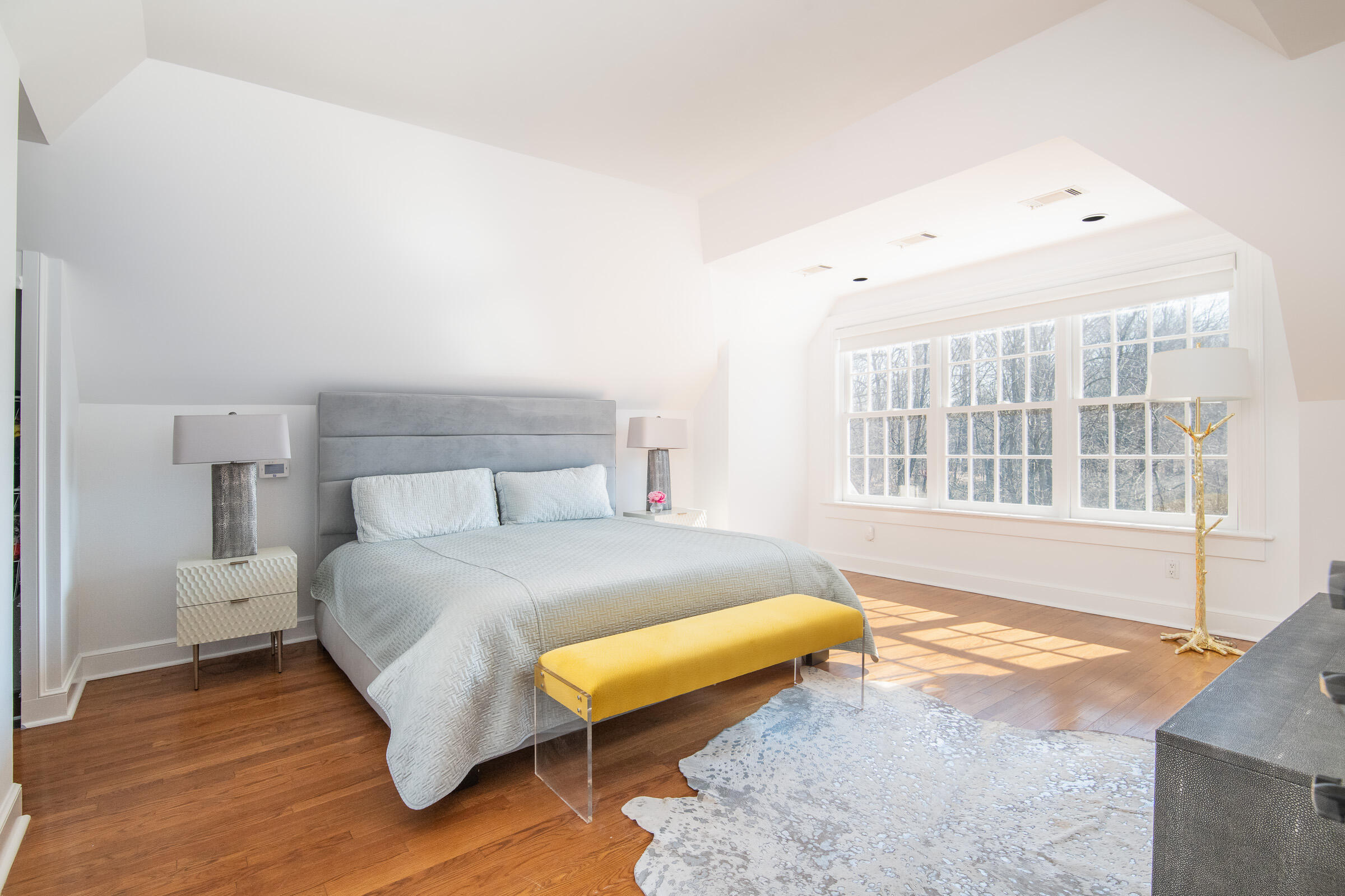 65 Sunset Hill Road New Canaan, CT 06840 - Photo 13 of 21 a spacious bedroom with a bed and wooden floor