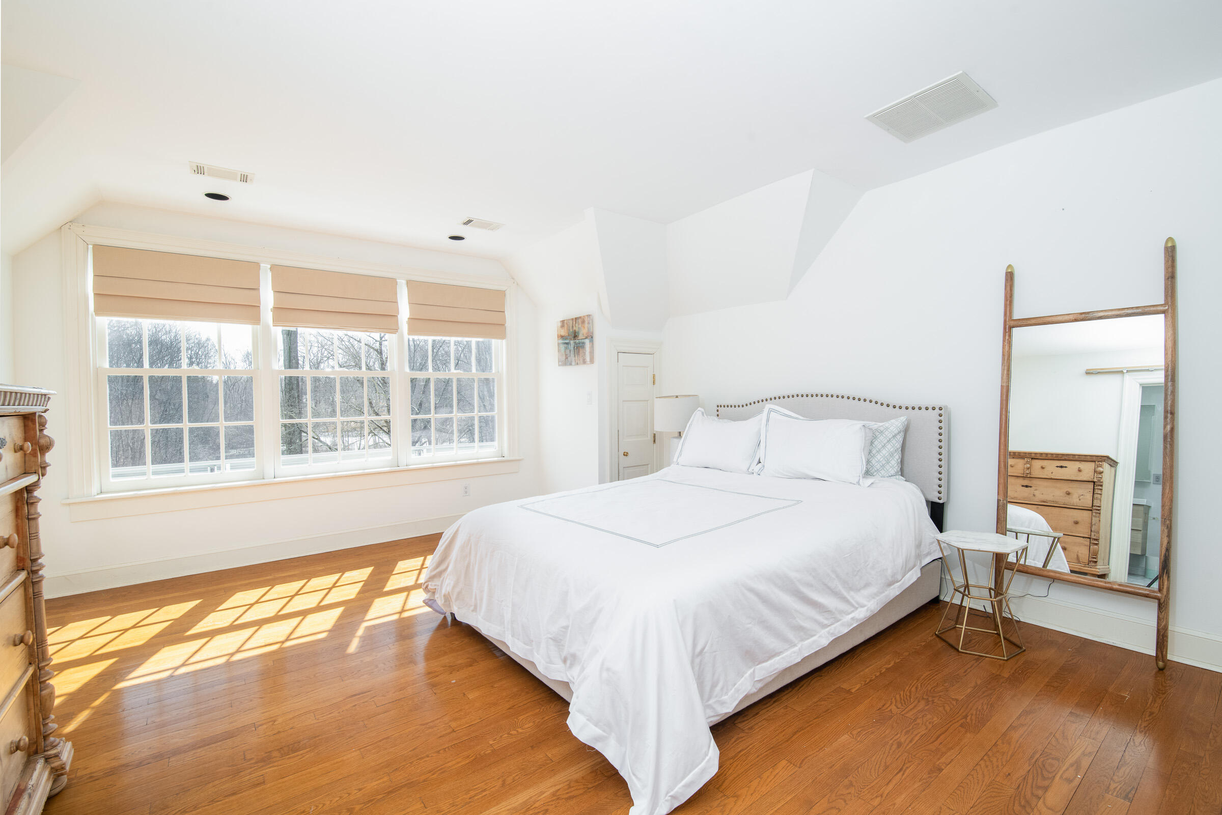 65 Sunset Hill Road New Canaan, CT 06840 - Photo 16 of 21 a bedroom with a bed and a large window