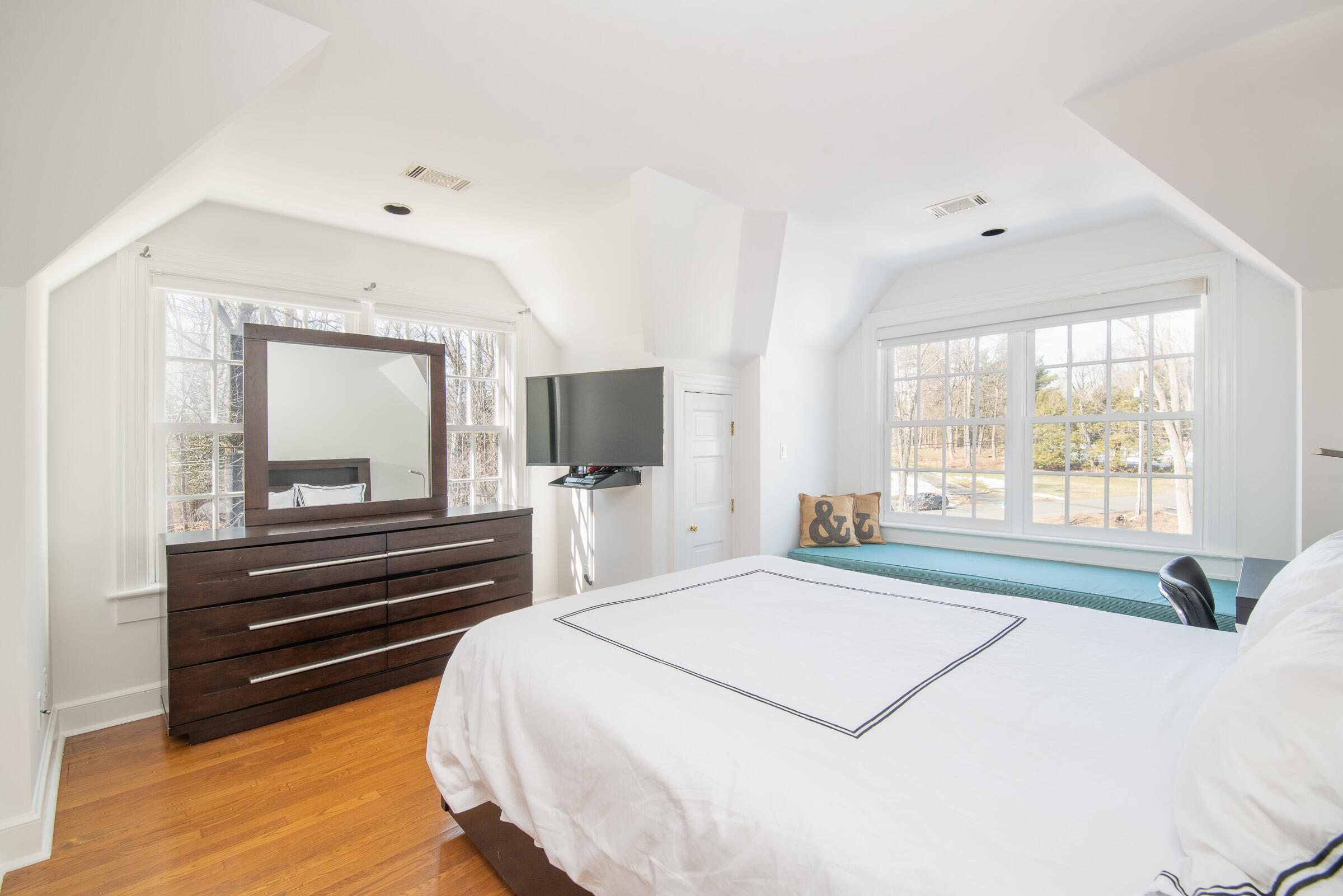 65 Sunset Hill Road New Canaan, CT 06840 - Photo 18 of 21 a bedroom with a bed and a flat screen tv