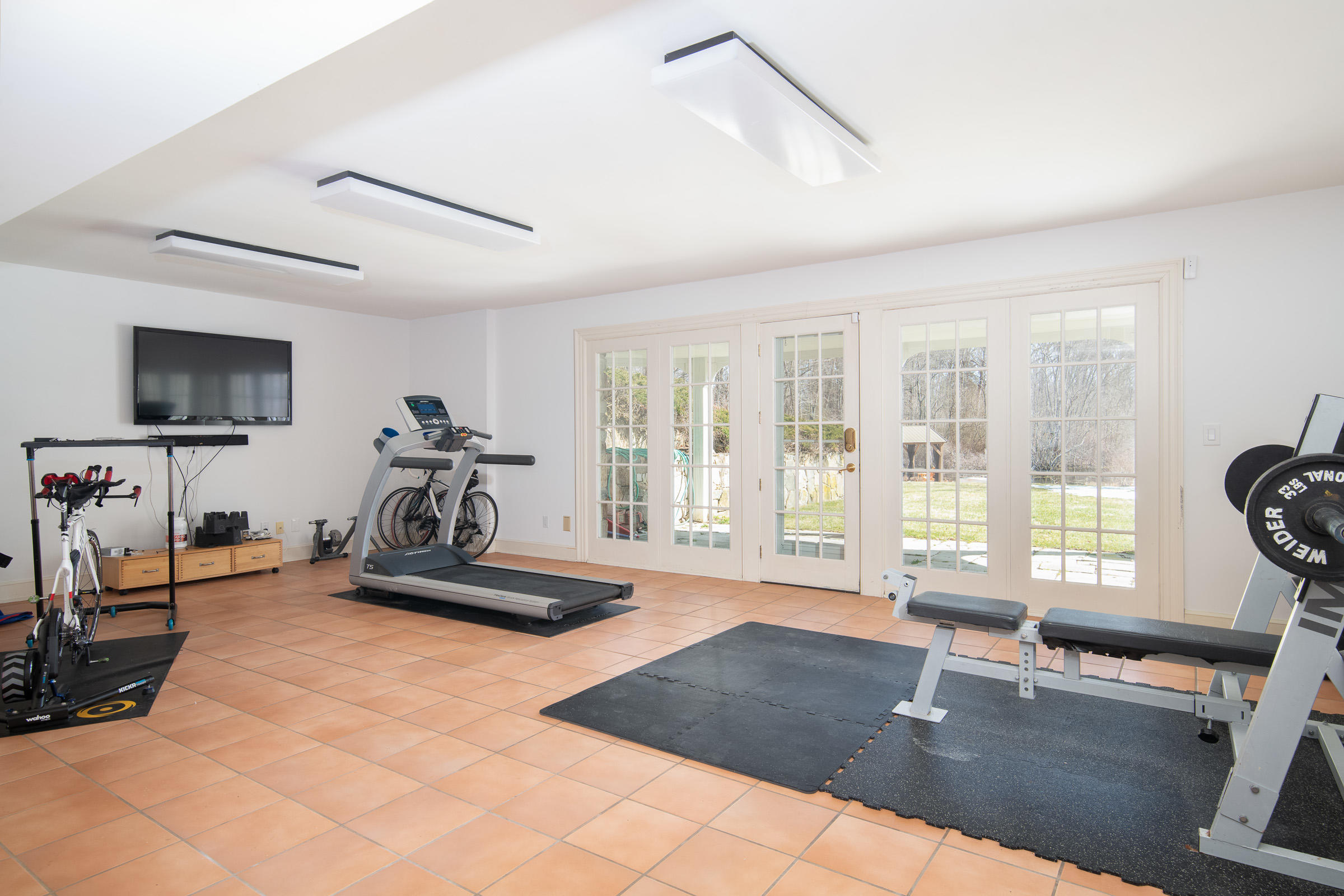 65 Sunset Hill Road New Canaan, CT 06840 - Photo 19 of 21 a room with gym equipment and a large window