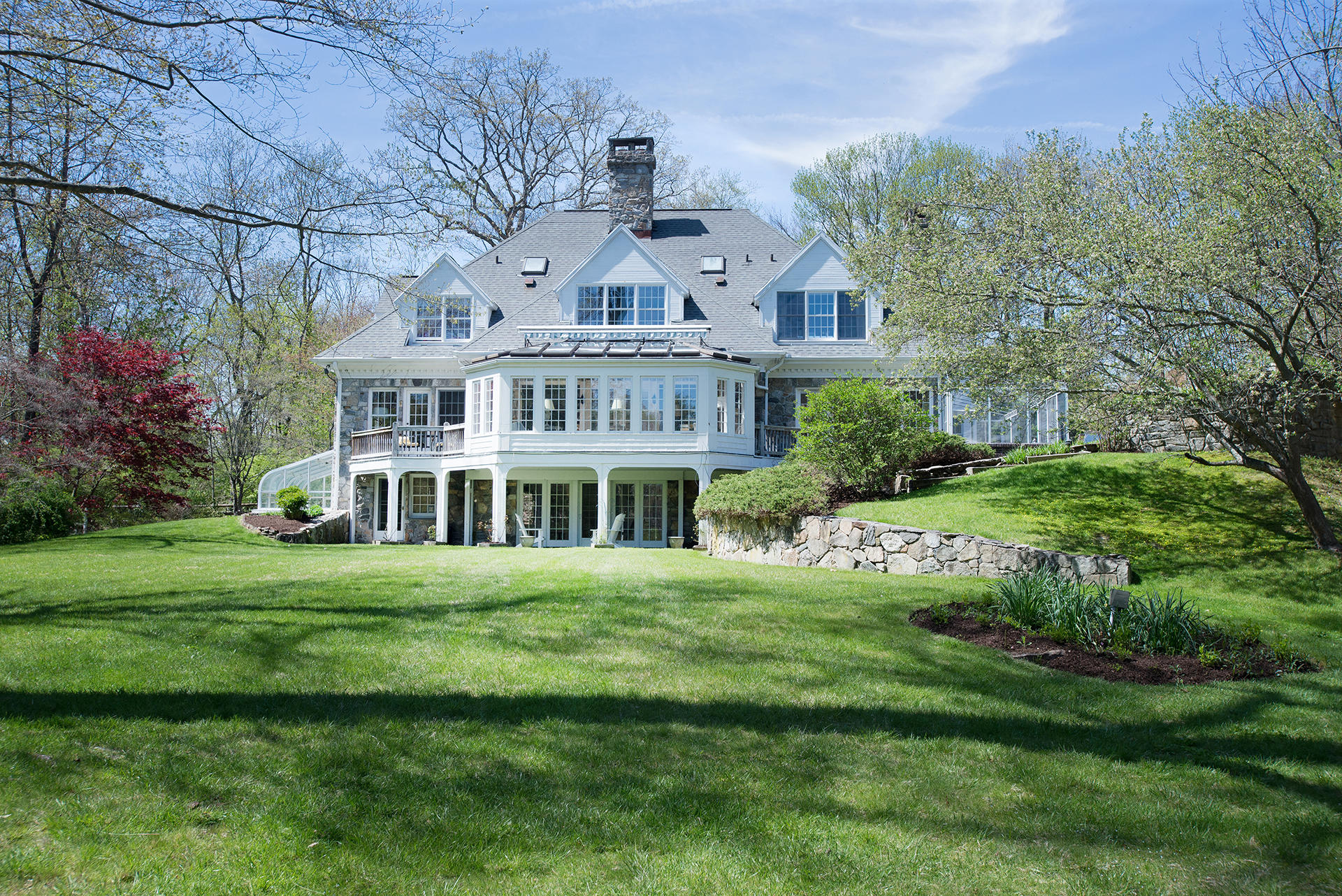 65 Sunset Hill Road New Canaan, CT 06840 - Photo 21 of 21 a front view of a house with a garden