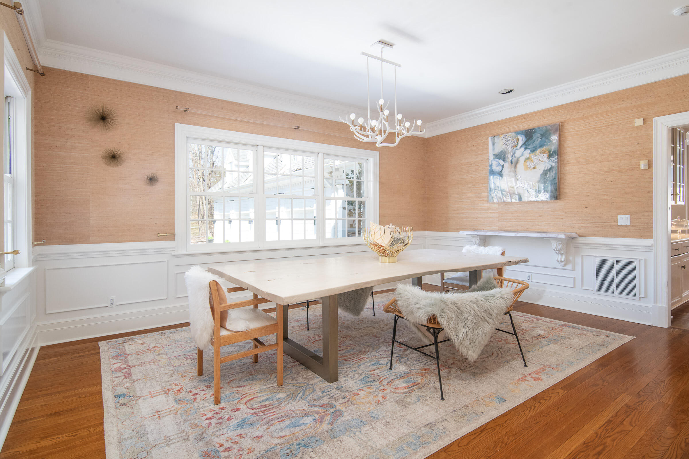65 Sunset Hill Road New Canaan, CT 06840 - Photo 4 of 21 a dining room with wooden floor and a chandelier