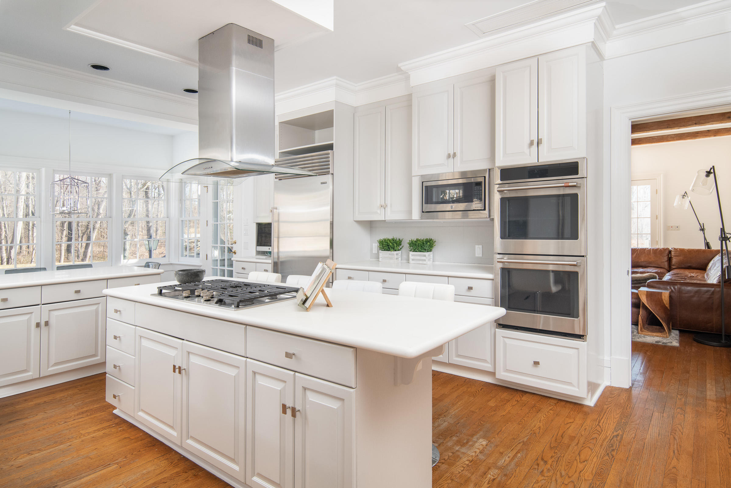 65 Sunset Hill Road New Canaan, CT 06840 - Photo 9 of 21 a kitchen with stainless steel appliances granite countertop a sink and cabinets with wooden floor