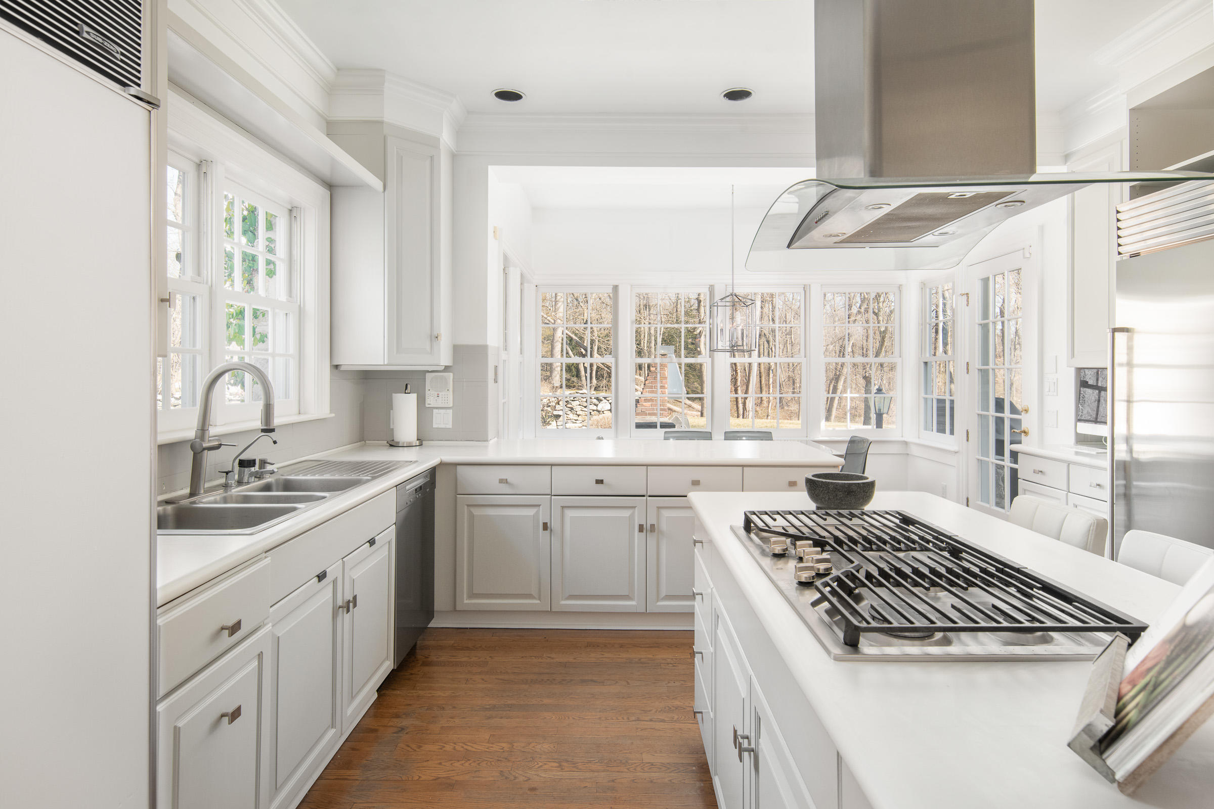 65 Sunset Hill Road New Canaan, CT 06840 - Photo 10 of 21 a kitchen with a sink stove and cabinets