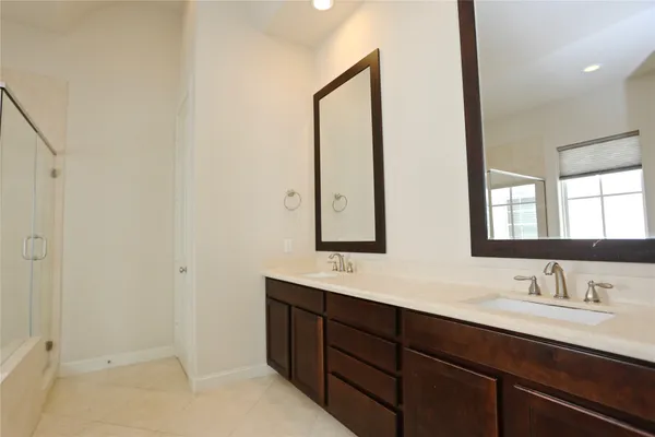 a bathroom with 2 sink and a mirror