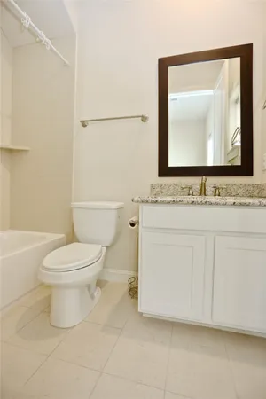 a bathroom with a toilet a sink and a mirror