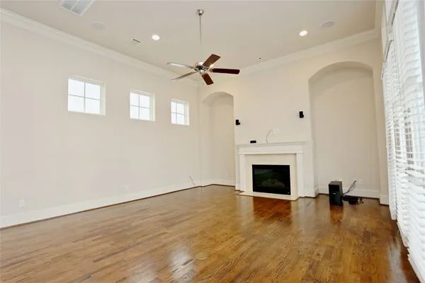 a view of a livingroom with wooden floor and a fireplace
