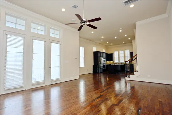 a view of a living room with hardwood floor and a ceiling fan