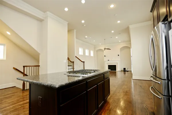 a kitchen with stainless steel appliances granite countertop a sink refrigerator and cabinets