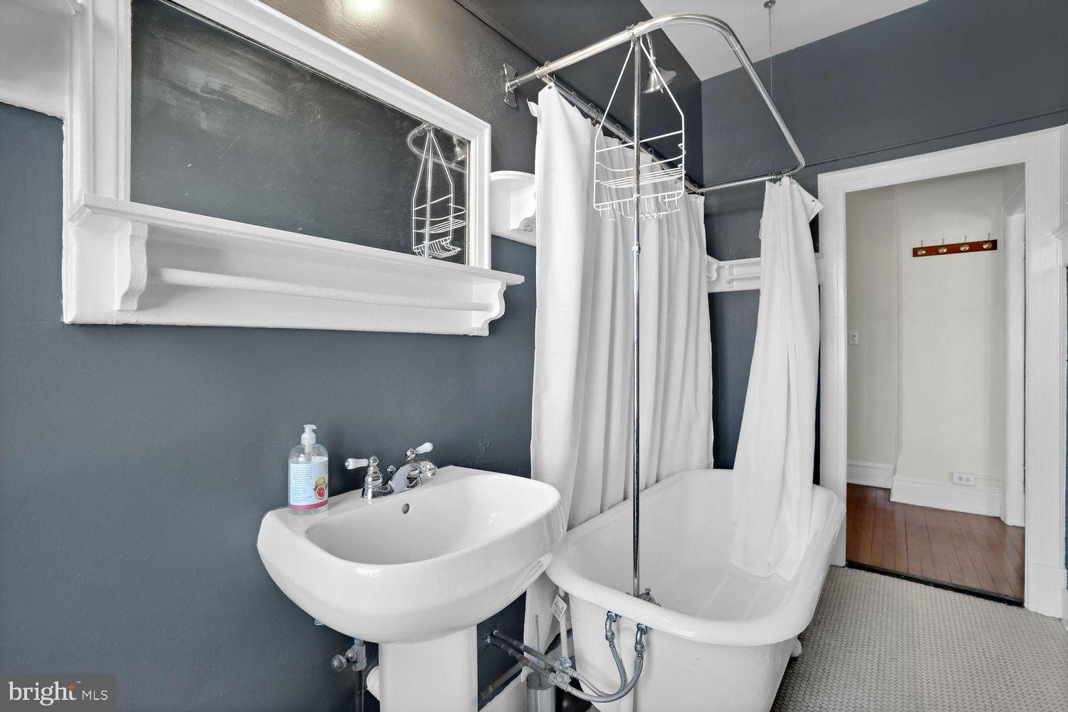 1725 17th Street Northwest, Unit 503 Washington, DC 20009 - Photo 13 of 24 a bathroom with a sink a mirror and a shower