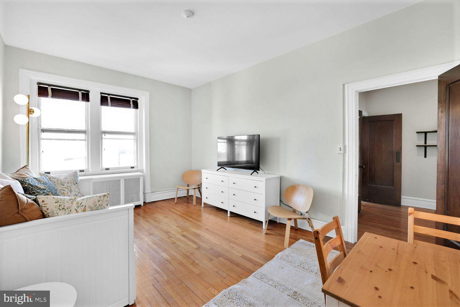 1725 17th Street Northwest, Unit 503 Washington, DC 20009 - Photo 2 of 24 a living room with furniture and a window