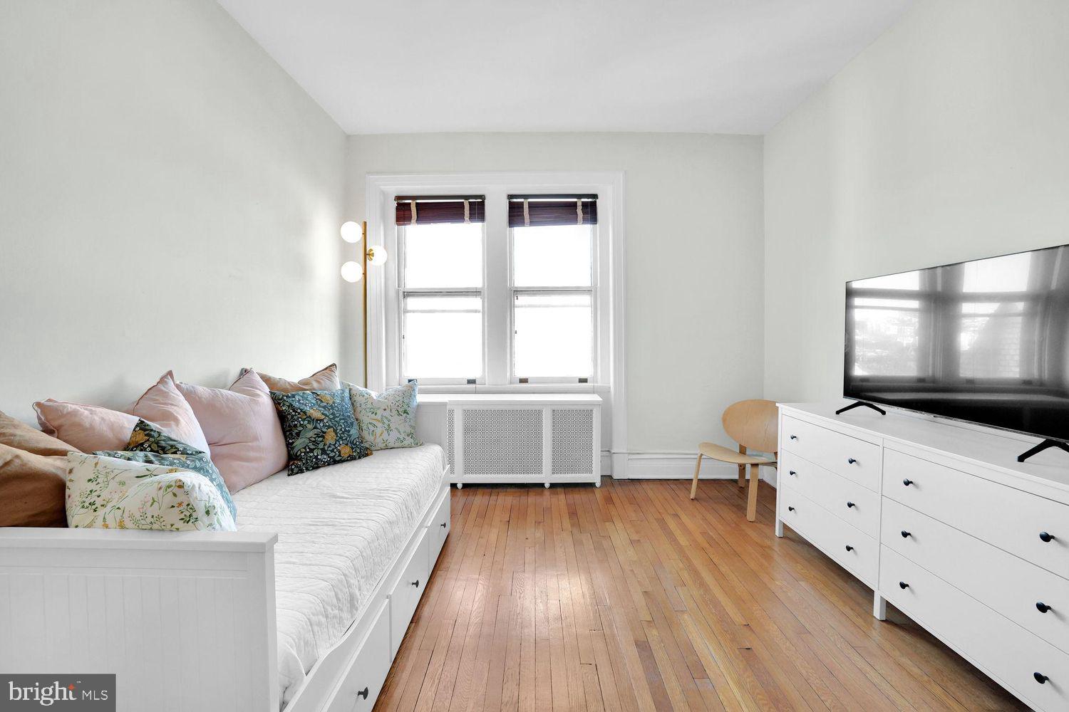 1725 17th Street Northwest, Unit 503 Washington, DC 20009 - Photo 3 of 24 a living room with furniture and a flat screen tv