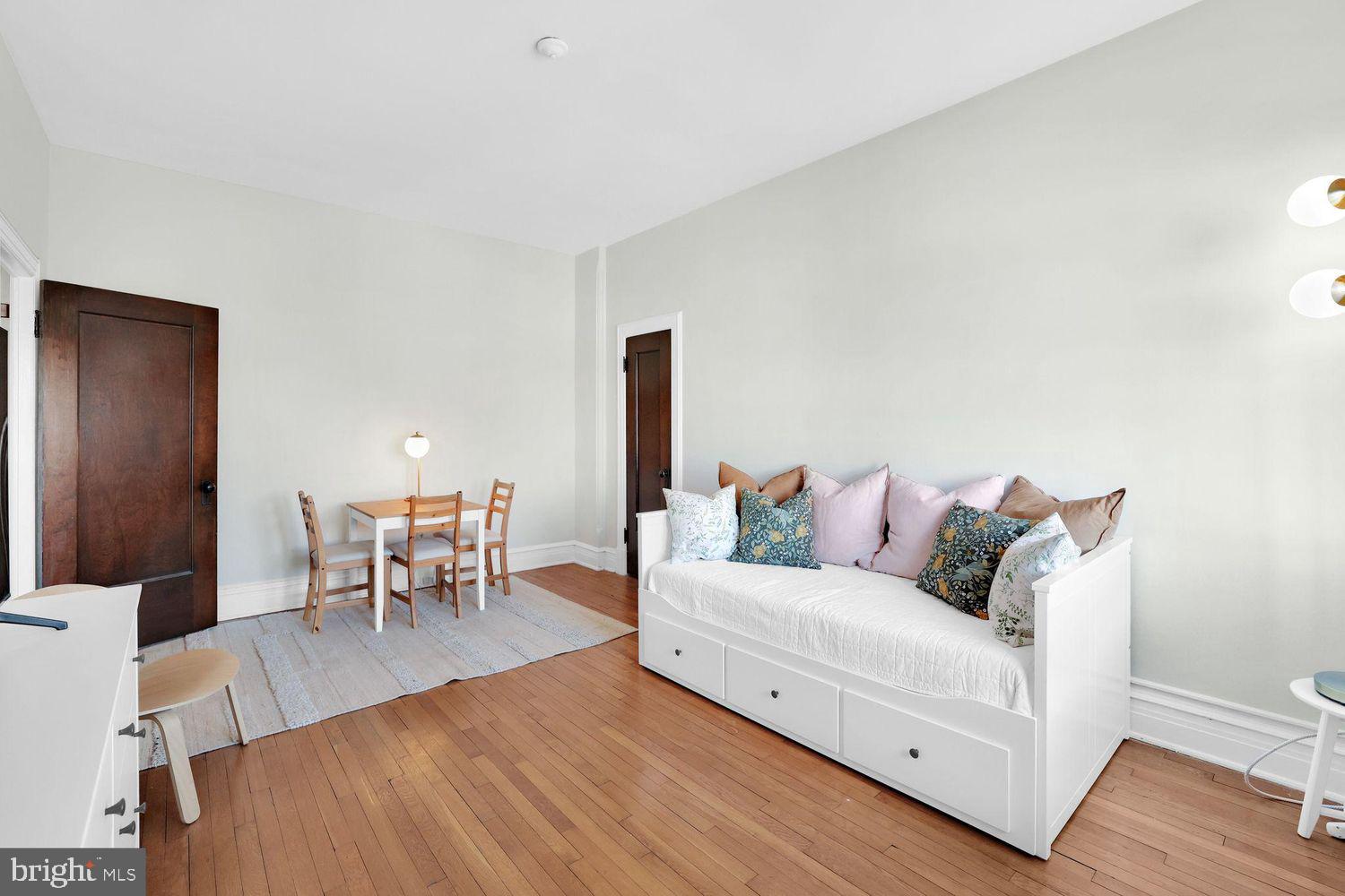 1725 17th Street Northwest, Unit 503 Washington, DC 20009 - Photo 5 of 24 a living room with furniture a table and a potted plant